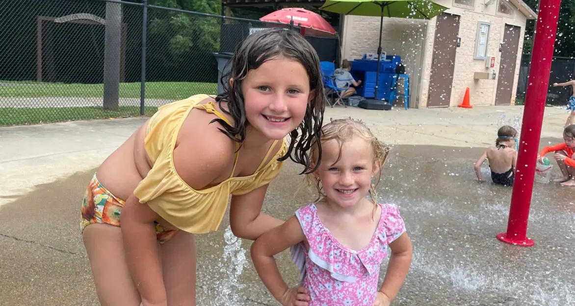 two girls at the splash pad in cline park