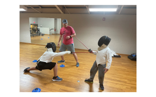 two kids practicing fencing